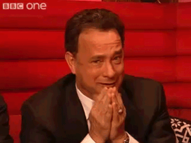 A gif of Tom Hanks looking into the camera, shaking his head and holding his hands up in a gesture of supplication. He mouths no, please no.